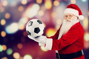 Portrait of attractive cheerful fat white-haired Santa holding in hands soccer ball having fun