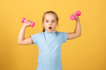 Girl workout in park. Kids sport. Child exercising with dumbbells. Sporty and fitness child with dumbbell outdoor. Kids sport. Kids active healthy lifestyle.
