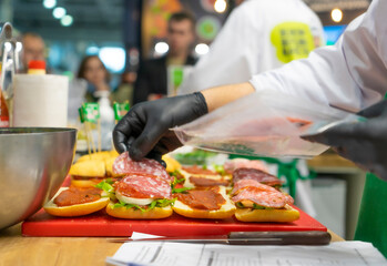 preparation of many sandwiches in the restaurant kitchen Closeup image of a chef cooking sandwich...
