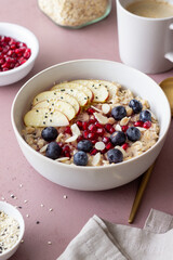 Oatmeal porridge with apple, pomegranate, blueberries and almonds. Healthy eating. Vegetarian food. Breakfast.
