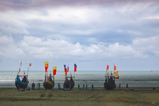 Wooden moon boats docked at the beach in Cox's Bazar, Bangladesh