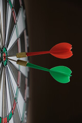 Dartboard with darts stuck right in center of the target.
