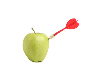 Obraz premium Red dart for playing darts hits straight into apple.Concept of competition and achievement goals.Achieving goals in business and life.