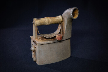 Ironing iron on black background, vintage