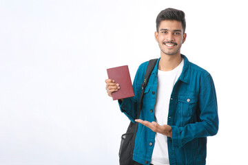 Indian college boy showing diary on white background.