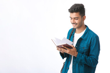 Young Indian college student holding dairy in hand on white background.