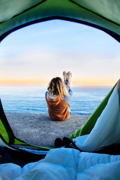 View From A Tent Of A Beautiful Young Woman Relaxing On The Sandy Beach