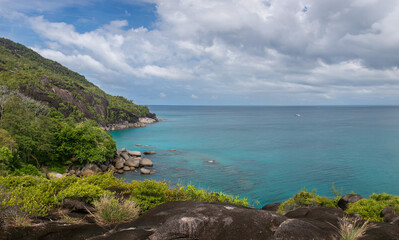 View from a high cliff overlooking the turquoise bay of the Indian Ocean in the Seychelles. The...