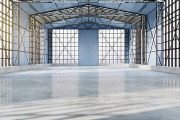 Bright spacious concrete empty hangar interior with sunlight, city view and window frames. Factory and industrial concept. 3D Rendering.