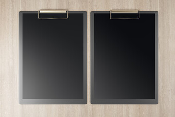 Top view and close up of clean black clipboards on wooden background, Stationery and mock up supplies concept. 3D Rendering.