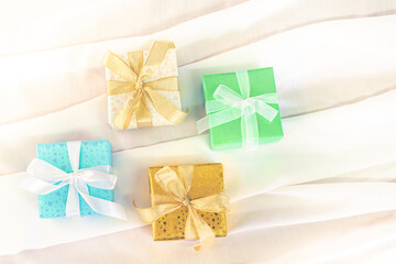 Beautiful Christmas gift boxes. Colored Presents for Birthdays. Boxes with gifts tied with ribbon and bows background. craft paper present box. Christmas tree toys and lights. happy new year 