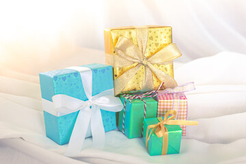 Beautiful Christmas gift boxes. Colored Presents for Birthdays. Boxes with gifts tied with ribbon and bows background. craft paper present box. Christmas tree toys and lights. happy new year 
