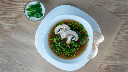 Close-up view of mushroom soup with green onions and champignons. Healthy food concepts.