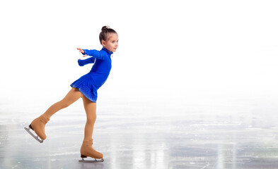 A Little young figure skater posing in blue training dress on ice on white background