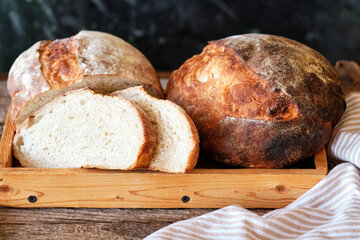 Homemade sourdough bread. Wooden background, side view, horizontal