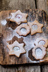 christmas linzer cookies with spices ion a wooden board