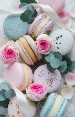 Beautiful colorful tasty macaroons on a concrete background