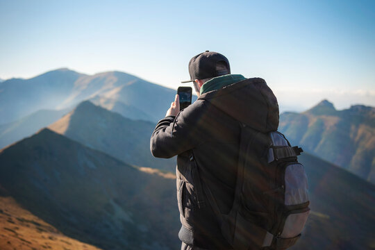 Tourist takes on smartphone mountain scenery