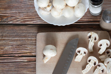 Fresh porcini mushrooms on a cutting board. On a tree background