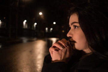 A lonely girl walks around the city at night.