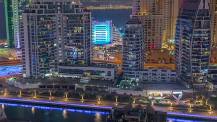 Fototapeta na wymiar Dubai Marina skyscrapers and JBR district with luxury buildings and resorts aerial night timelapse