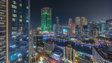 Fototapeta na wymiar Dubai Marina skyscrapers and JBR district panorama with luxury buildings and resorts aerial night timelapse