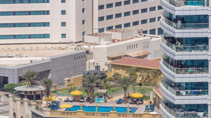 Rooftop swimming pool viewed from above timelapse, Aerial top view at Dubai marina.