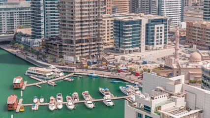 Many yachts and boats are parked in harbor aerial timelapse in Dubai Marina