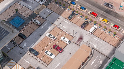 Aerial view of car crowded parking lot near apartment buildings all day timelapse.
