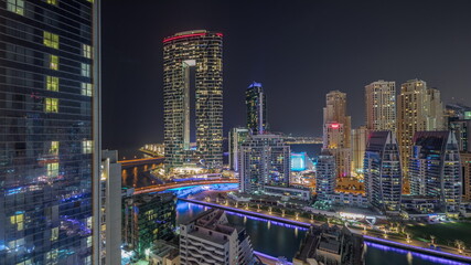 Fototapeta na wymiar Dubai Marina skyscrapers and JBR district with luxury buildings and resorts aerial timelapse during all night with lights turning off.