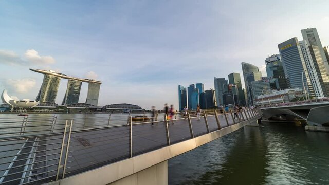 Singapore, Singapore - Feb 3, 2020: Time-lapse of people walk in business district Marina bay Singapore, skyscraper tower buildings. Pedestrian transportation, Asia travel, or Asian city life concept