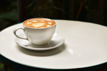 White coffee cup on white table.