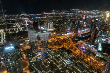 Obraz na płótnie Canvas Dubai, United Arab Emirates – December 14, 2021, the people visiting the the 24th and 25th floor of Burj Khalifa at night and shopping souvenirs at the shop