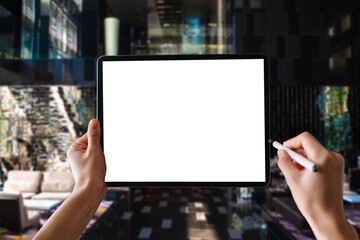 a woman using blank screen tablet with stylus on dark