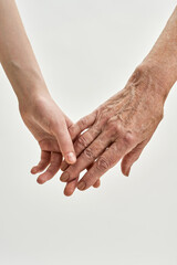 Senior grandmother and young girl holding hands
