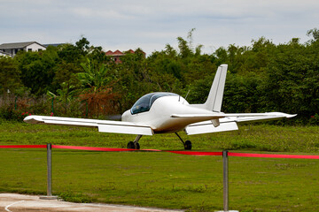 A small plane on the runway of a civil airport prepares to take off