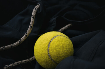 Sports games in tennis. An accessory for an athlete, a tennis ball on sportswear