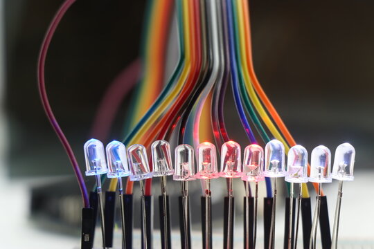 Light emitting diode or LED with glowing lights arranged in a breadboard and connected with jumper wires