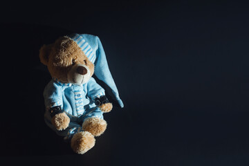 Toy bear is kneeling, facing the wall, hands behind his back in handcuffs. Child abuse. Abduction...