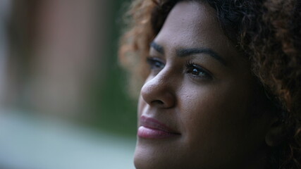 Spiritual black woman closing eyes in contemplation, Brazilian girl opening eye to sky with HOPE