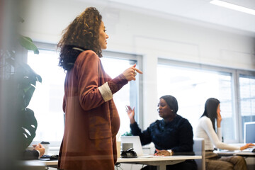 Businesswoman with male and female colleagues working in office