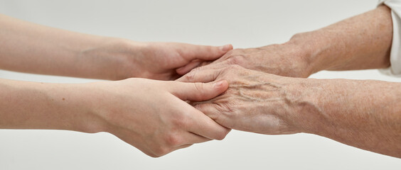 Grandma and girl holding hands each other