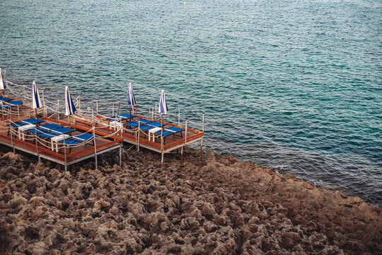 Santa Maria di Leuca, Italy-June 2021: deck chairs on the beautiful coastiline in the southern part of Puglia