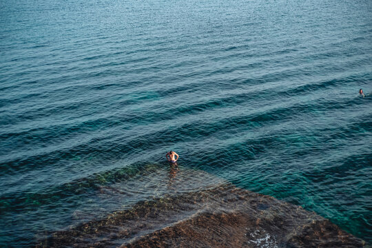 Santa Maria di Leuca, Italy-June 2021: a boy swimming in the beautiful sea of Puglia