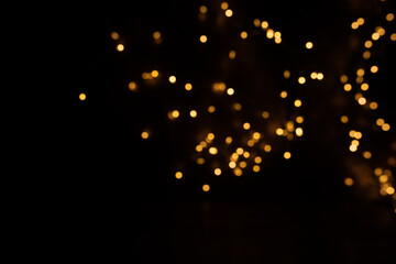 Abstract golden bokeh lights
Abstract black background with luminous golden bokeh lights. Background for christmas. Concept for glamorous and luxury. Space for text.