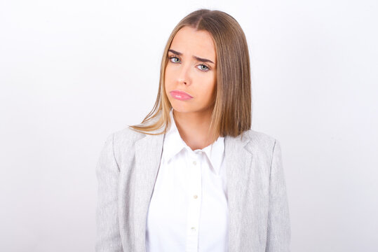 Young business woman wearing jacket over white background depressed and worry for distress, crying angry and afraid. Sad expression.