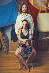 art portrait of a young couple. artist man and woman body art