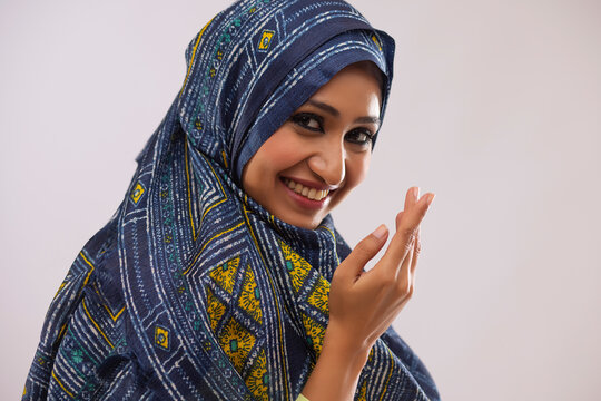 Portrait of beautiful Muslim woman greeting