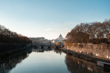 Rome, Italy. Vatican dome of Saint Peter Basilica (Italian: San Pietro) and Sant'Angelo Bridge, over Tiber river.
