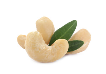 Tasty organic cashew nuts and green leaves isolated on white